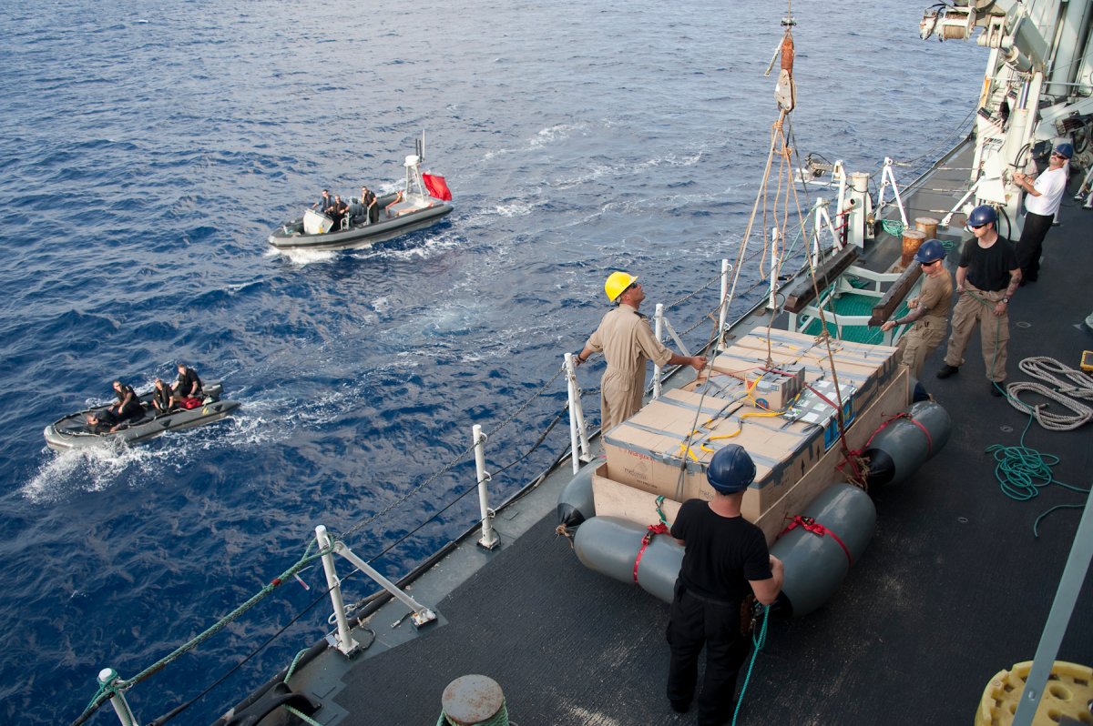The crew of Her Majesty's Canadian Ship (HMCS) TORONTO prepares to hoist a raft with seized narcotics primed for explosive destruction in the Indian Ocean during Operation ARETEMIS on May 24, 2013. (File photo).