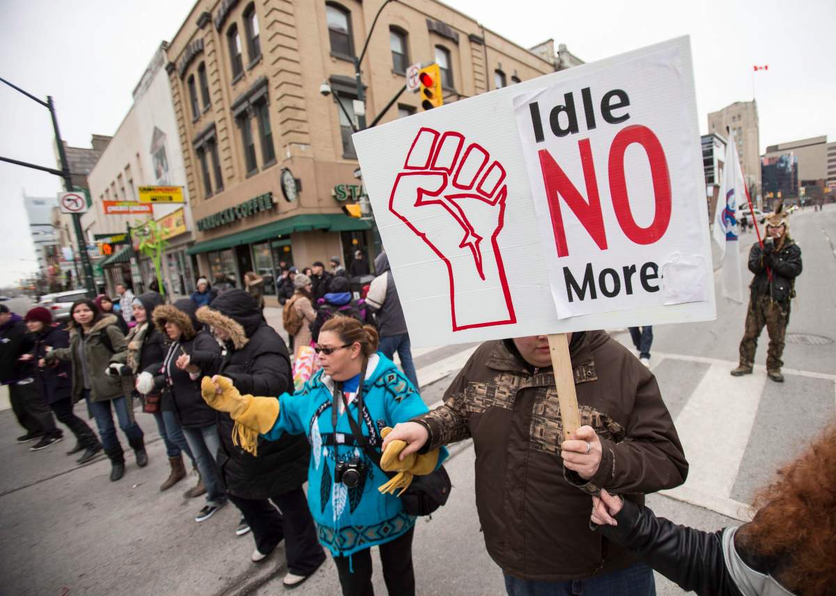 Demonstrators with the Idle No More movement block an intersection in downtown London Ontario, Thursday, March 21, 2013. THE CANADIAN PRESS/ Geoff Robins.
