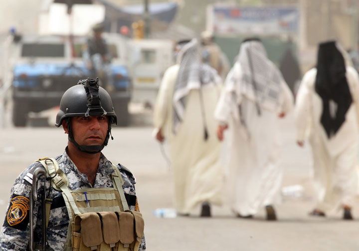 Iraqi troops guard a main road in Baghdad on June 4, 2013.