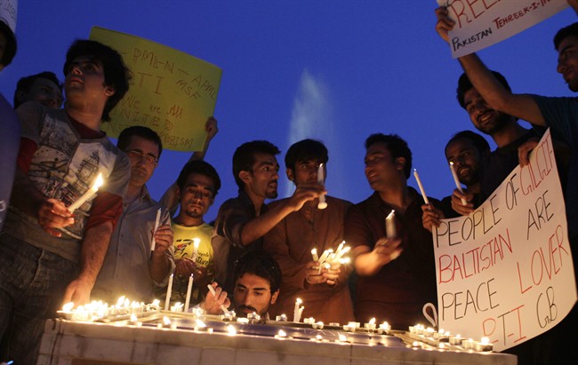 Members of a Civil Society hold candle light vigil in memory of the foreign tourists killed by Islamic militants, Saturday, June 29, 2013, in Lahore, Pakistan. 