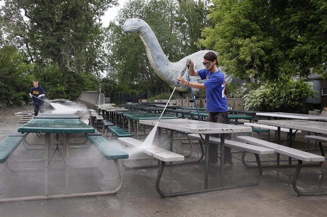 Clean-up crews work at the Calgary Zoo in Calgary, Alta., Tuesday, June 25, 2013. THE CANADIAN PRESS/Jeff McIntosh