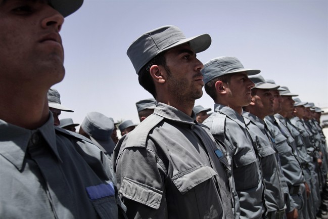 Afghan soldiers attend a transfer of authority ceremony of the police academy from NATO-led troops to Afghan security forces in Kabul, Afghanistan.