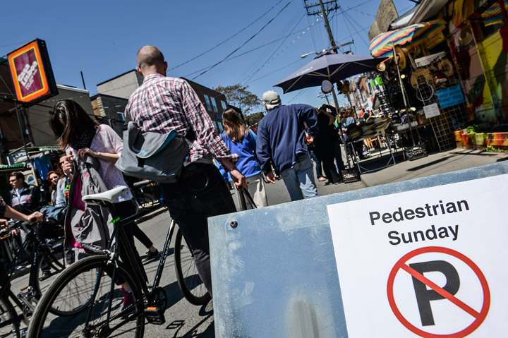 Pedestrians cruise the streets of Toronto's Kensington Market May 26, 2013 during Pedestrian Sunday.