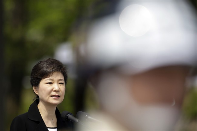 File - South Korean President Park Geun-hye delivers a speech as a military soldier stands guard during a 58th Memorial Day ceremony at the National Cemetery in Seoul, South Korea, Thursday, June 6, 2013. 