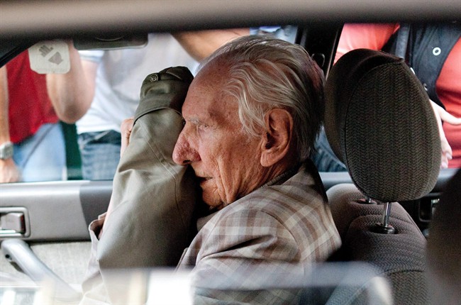 In this Wednesday, July 18, 2012 file photo, alleged Hungarian war criminal Laszlo Csatary sits in a car as he leaves the Budapest Prosecutor's Office after he was questioned by detectives on charges of war crimes during WWII and prosecutors ordered his house arrest in Budapest, Hungary.