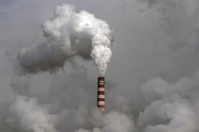 Smoke billows from a chimney of the cooling towers of a coal-fired power plant in Dadong, Shanxi province, China. 