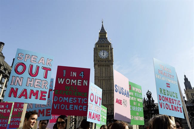 FILE - In this Tuesday, March 5, 2013 file photo people hold banners during a demonstration against domestic violence near Big Ben in London, in the lead up to International Women's Day. About a third of women worldwide have been physically or sexually assaulted by a former or current partner, according to the first major review of violence against women. In a series of papers released on Thursday June 20, 2013 by the World Health Organization and others, experts estimated nearly 40 percent of women killed worldwide were slain by an intimate partner and that being assaulted by a partner was the most common kind of violence experienced by women. (AP Photo/Kirsty Wigglesworth, File).