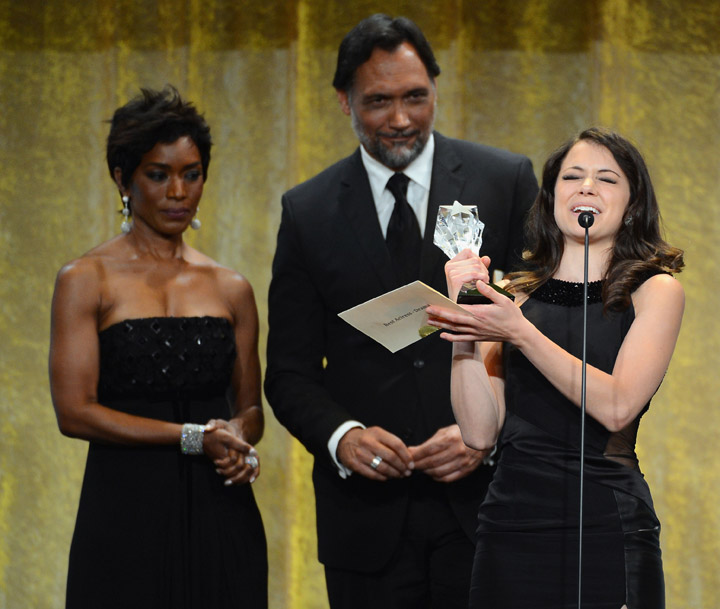 Tatliana Maslany accepts the Best Actress in a Drama Series trophy from Angela Bassett and Jimmy Smits at the Critics' Choice Television Awards.