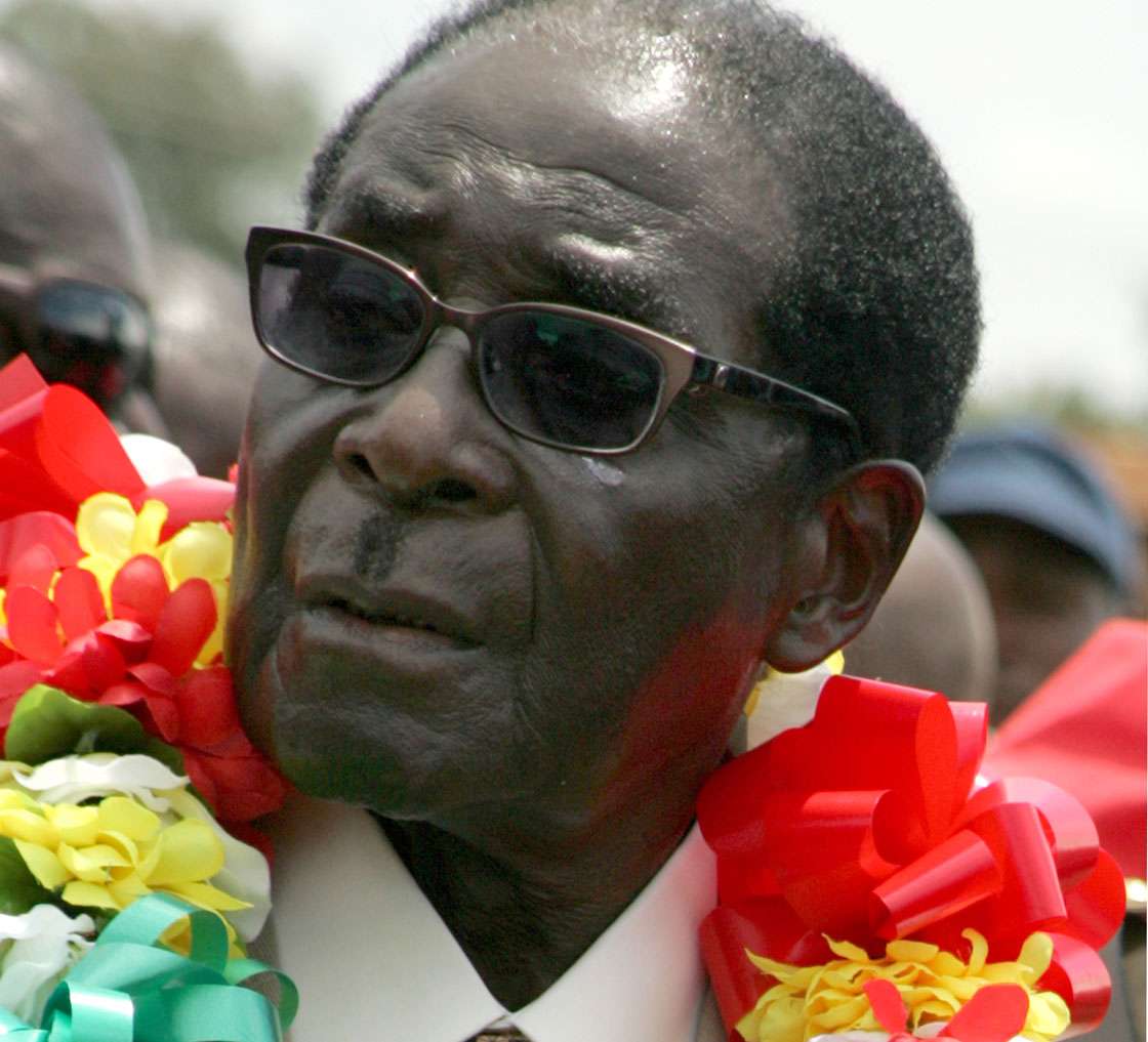 Zimbabwe's President Robert Mugabe wears a garland during a rally held on March 2, 2013 at Chipadze stadium in Bindura as part of the 21st February Movement celebrations held in honor of his 89th birthday.