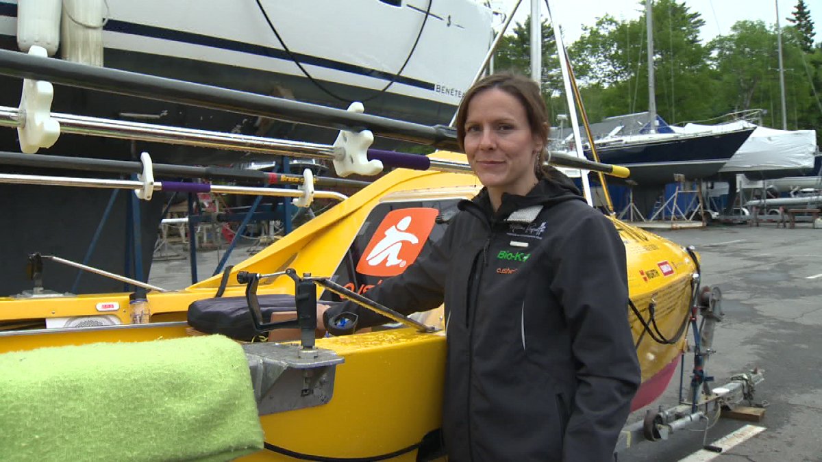 Paquette poses with her boat, as she prepares to leave Halifax.