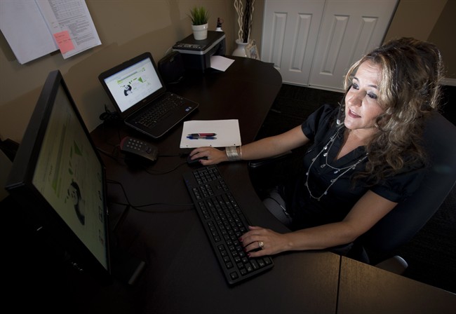 Telus Mobility employee Ana Aresta works from her home in Delta, B.C. on Thursday, June 20, 2013. 