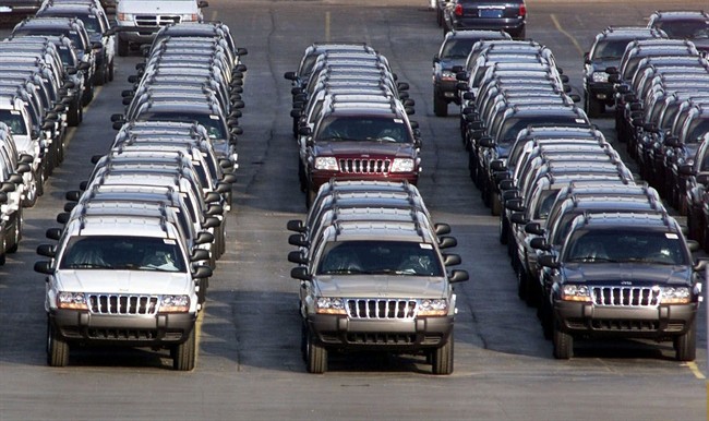 In this Feb. 2, 2001 file photo, rows of 2001 Jeep Grand Cherokees are lined up outside the Jefferson North Assembly Plant in Detroit.