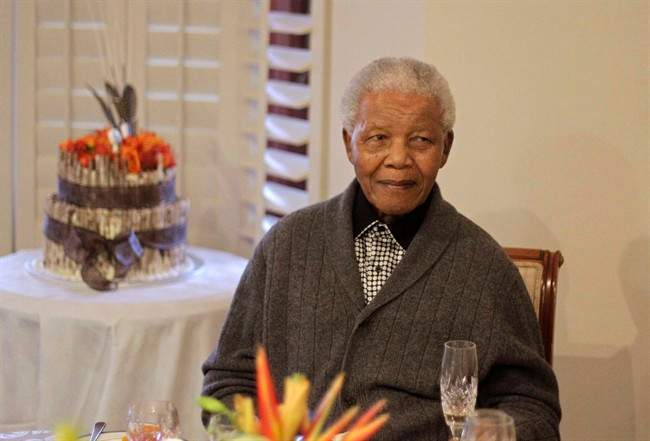 FILE - In this Wednesday, July 18, 2012 file photo, former South African President Nelson Mandela celebrates his birthday with family in Qunu, South Africa. 