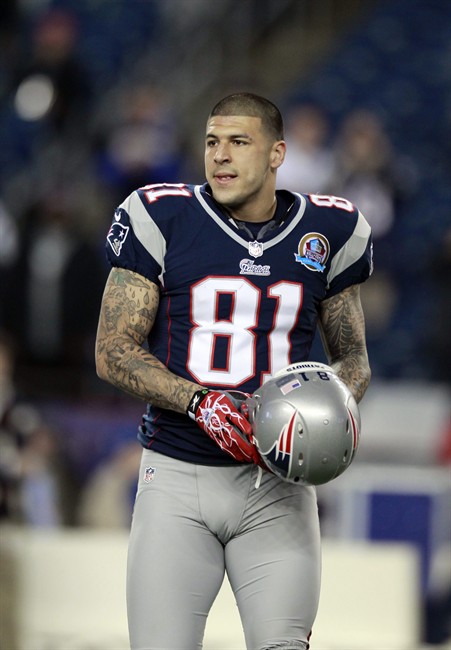 FILE - In this Dec. 10, 2012 file photo, New England Patriots tight end Aaron Hernandez (81) holds his helmet as he steps onto the field before an NFL football game between the New England Patriots and the Houston Texans in Foxborough, Mass. 