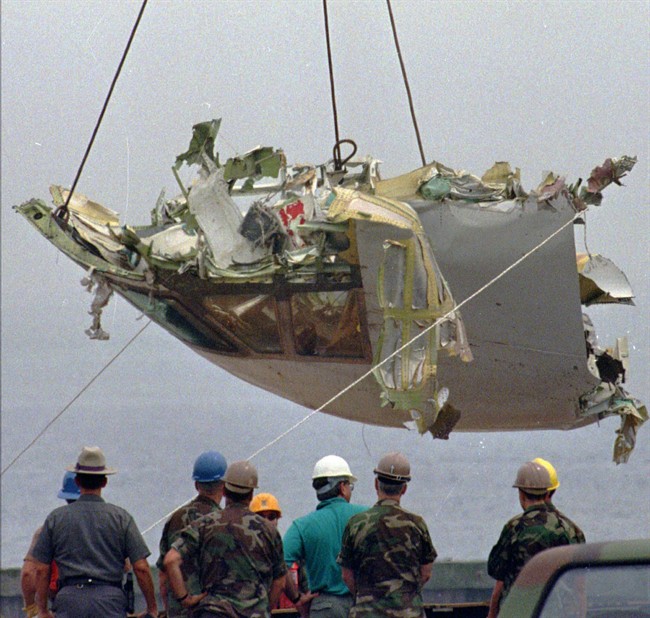 FILE - In this Aug. 7, 1996 file photo, the cockpit of TWA Flight 800 is lowered at the U.S. Coast Guard station at Shinnecock Inlet in Hampton Bays, N.Y. 