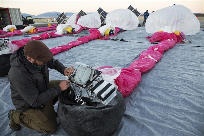 In this June 10, 2013 photo released by Google, Jordan Miceli prepares electronics to launch balloons in Tekapo, New Zealand.