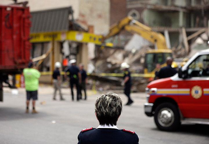 Lynda Raines with the Salvation Army views the demolition of one of their stores in the aftermath of a building collapse, Thursday, June 6, 2013, in Philadelphia. 