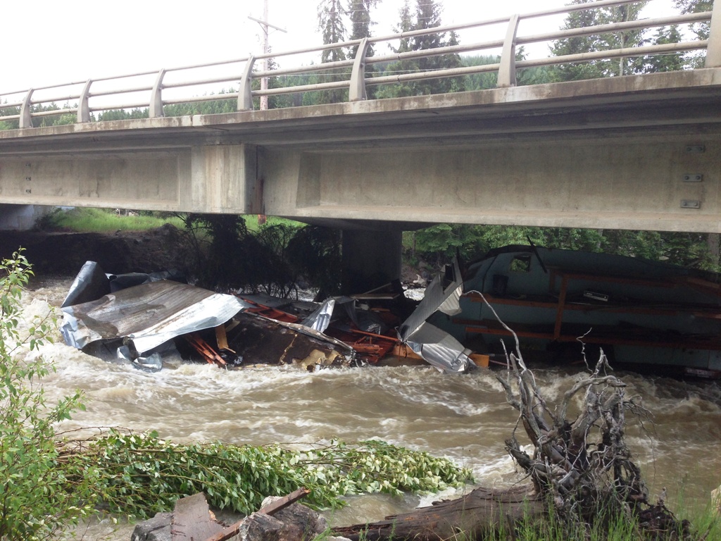 Trailer washes up against Highway 33 bridge pillar - image