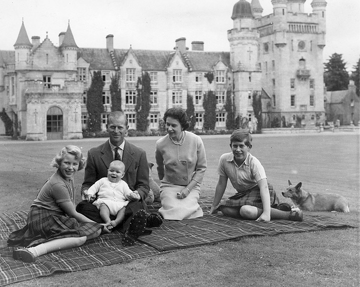 Queen Elizabeth II and Prince Philip, Duke of Edinburgh with their children, Prince Andrew (centre), Princess Anne (left) and Charles, Prince of Wales sitting on a picnic rug outside Balmoral Castle in Scotland in 1960.