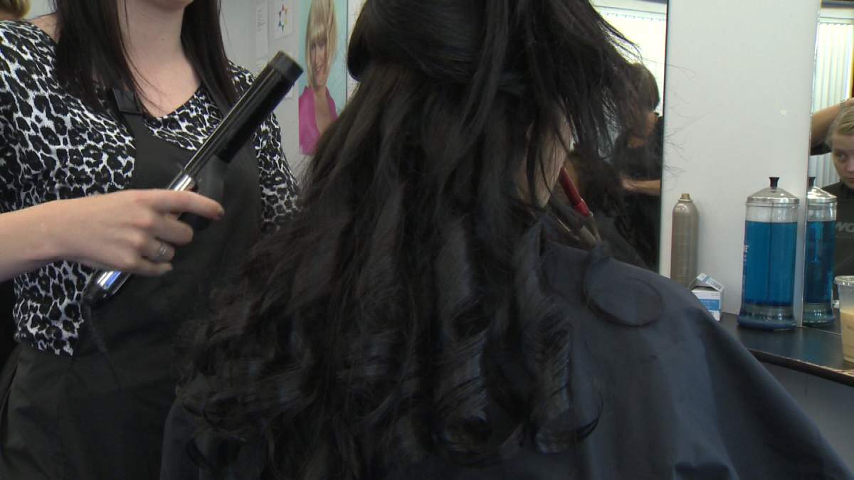 Lauren Vassallo gets her hair curled for her prom.