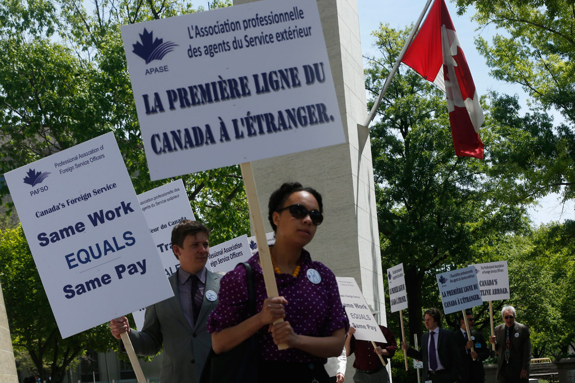 Canadian foreign service officers seen at protest in front of the Canadian Embassy in Washington, May 3, 2013. 