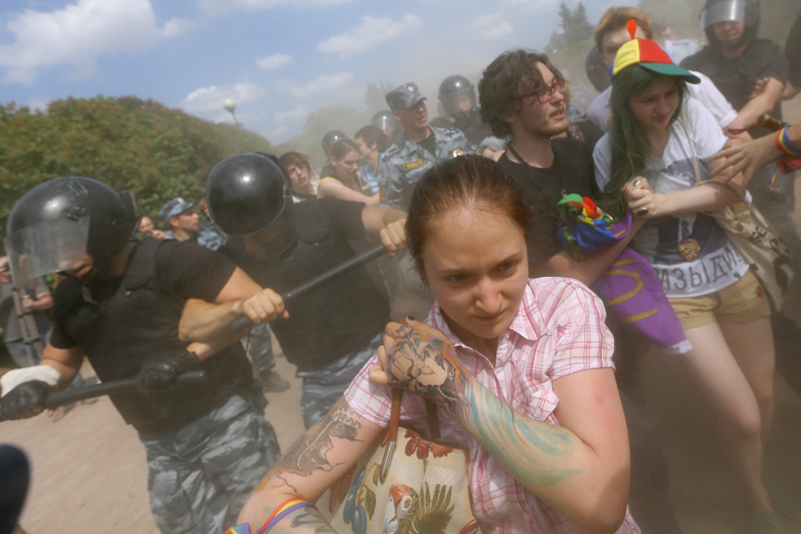 Riot police (OMON) officers detain gay rights activists during their authorized rally in St.Petersburg, Russia, Saturday, June 29, 2013.