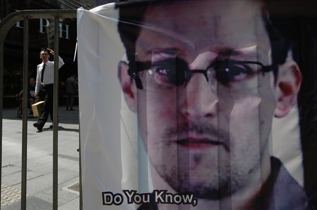 FILE - In this June 21, 2013 file photo, a banner supporting Edward Snowden, a former CIA employee who leaked top-secret documents about sweeping U.S. surveillance programs, is displayed at Central, Hong Kong's business district. Snowden has talked of seeking asylum in Iceland.