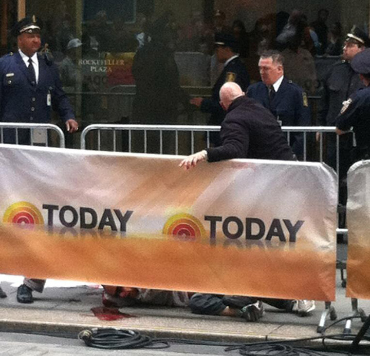 A man lies on the ground after cutting himself.