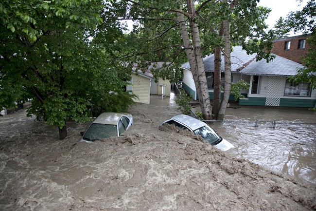 Submerged cars sits in the flood waters in High River, Alta. on June 20, 2013.