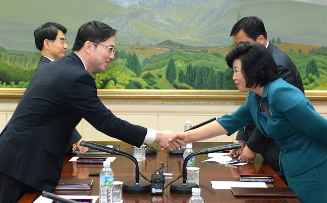 South Korea's Unification Policy Officer Chun Hae-sung, left, shakes hands with the head of North Korea's delegation Kim Song Hye, right, after ending their meeting at the southern side of Panmunjom Monday, June 10, 2013.