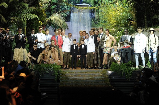 Fashion designers Dean and Dan Caten pose with models at the end of DSquared2 men's Spring-Summer 2014 collection, part of the Milan Fashion Week, unveiled in Milan, Italy, Tuesday, June 25, 2013. 