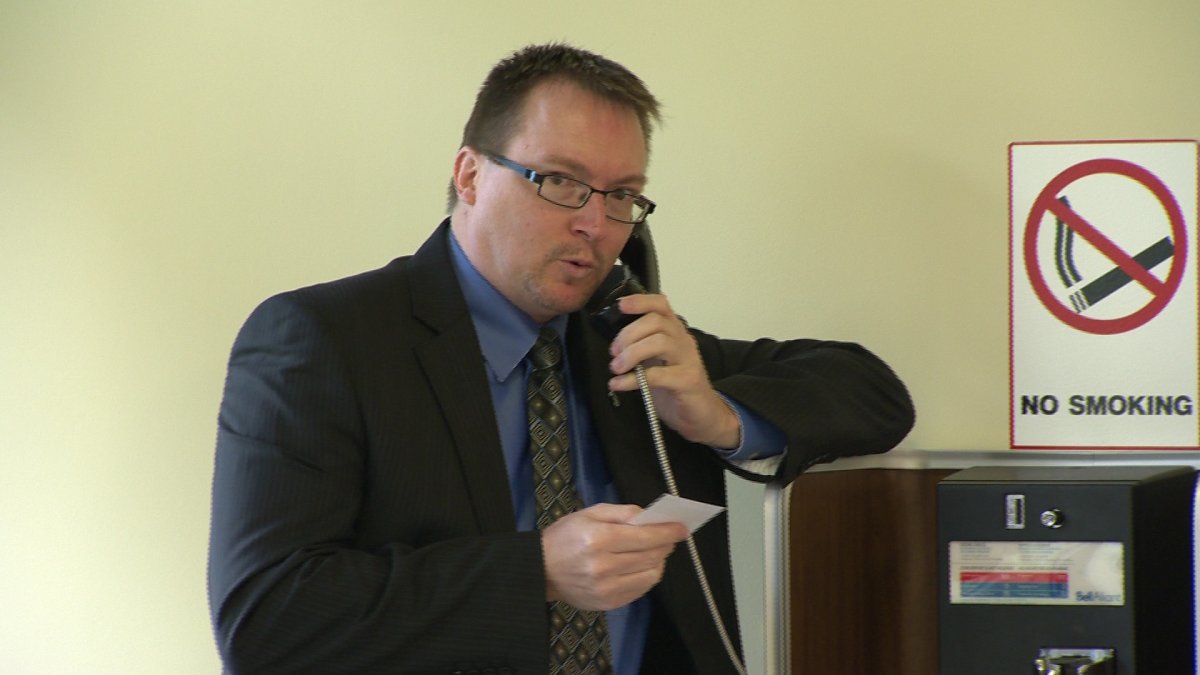 MLA Trevor Zinck uses a payphone outside Nova Scotia Supreme Court, Wednesday June 12, 2013.