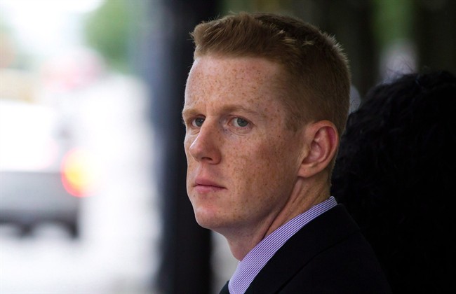 RCMP Const. Bill Bentley leaves court in Vancouver on June 11, 2013. Bentley has been found not guilty of lying at the inquiry into Robert Dziekanski's death. 
