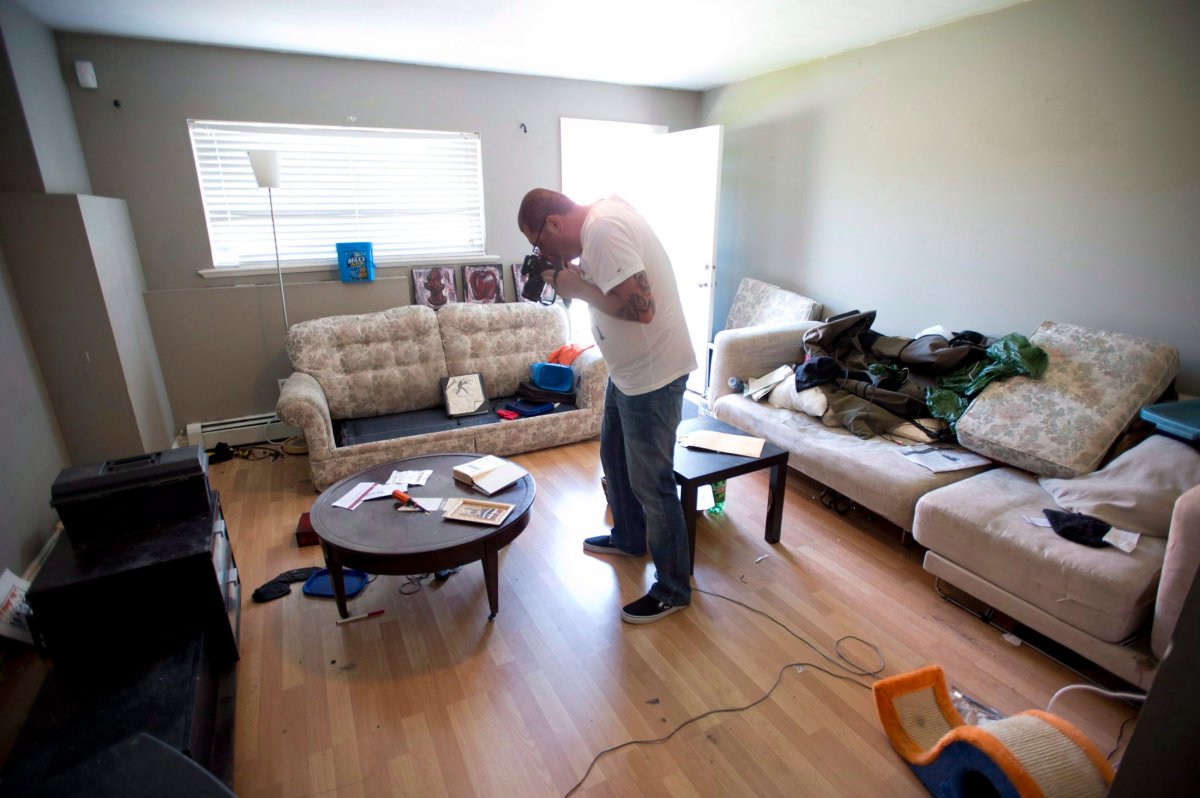 A photographer shoots pictures inside the apartment of alleged terror suspects John Nuttall and Amanda Korody in Surrey, B.C. Wednesday, July 3, 2013.