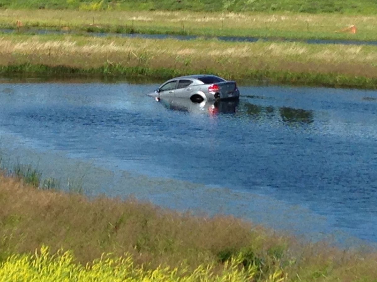 Emergency crews respond to car in the water near the Anthony Henday North and 97 Street, July 11, 2013.