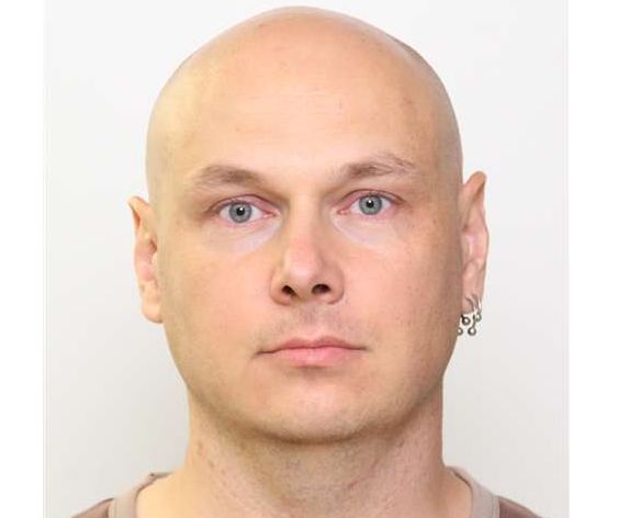 Mark Marek, 38, is Caucasian, 6 feet tall, weighs 230 lbs., originally has light brown hair, blue eyes, an earring in his left ear and speaks with a Slavic accent.