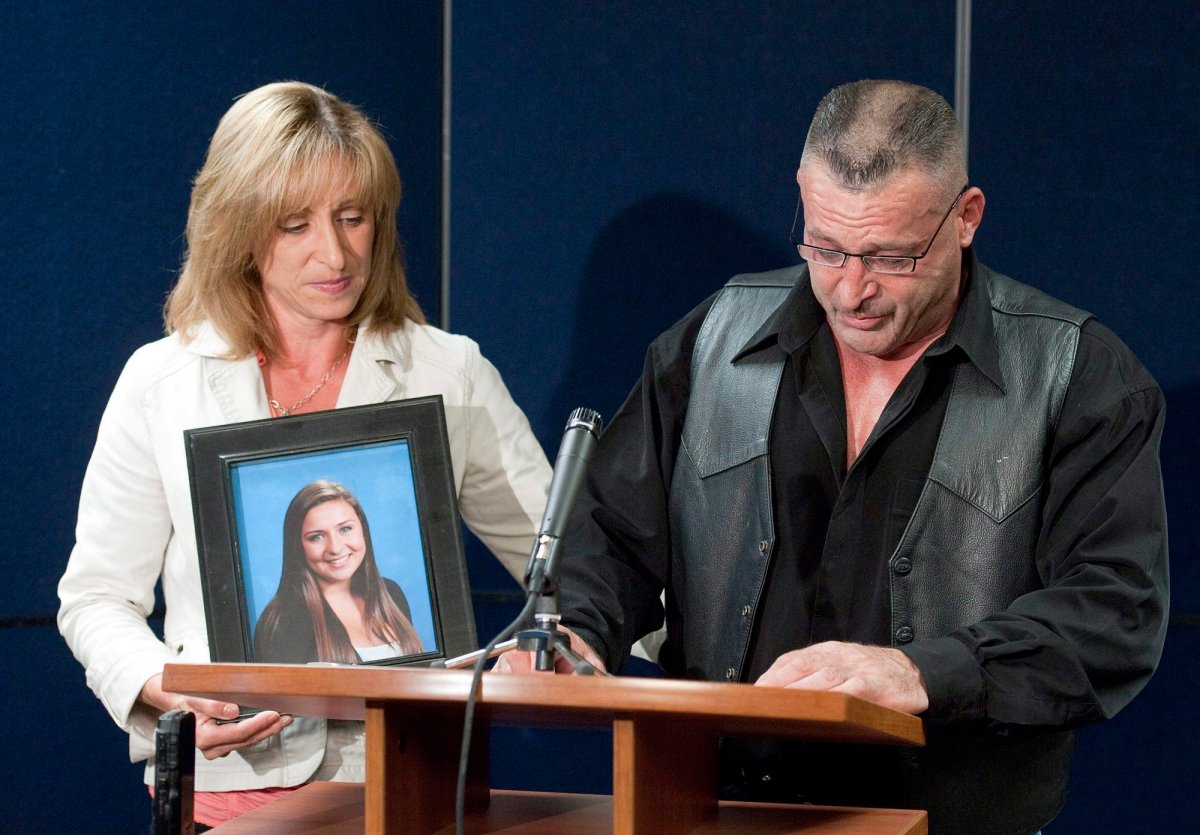 Mike Szendrei speaks to the media while his wife Rachel holds a picture of their daughter Laura during a press conference in North Delta, B.C., October 13, 2010. 