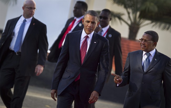 U.S. President Barack Obama walks with Tanzanian President Jakaya Kikwete, right, to a joint press conference after meeting together at State House in Dar es Salaam, Tanzania Monday, July 1, 2013. 