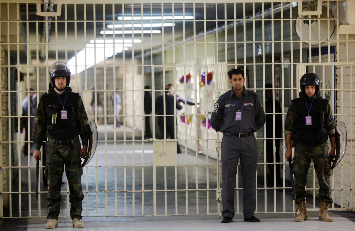 In this Feb. 21, 2009 file photo, guards stand at a cell block at the renovated Abu Ghraib prison, now renamed Baghdad Central Prison, where more than 500 inmates were freed after a large attack in 2013, in Baghdad, Iraq.