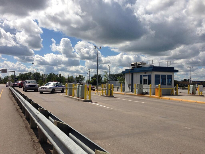 Saskatoon police investigate a possible suspicious package in the parking lot at John G. Diefenbaker Airport on Tuesday.