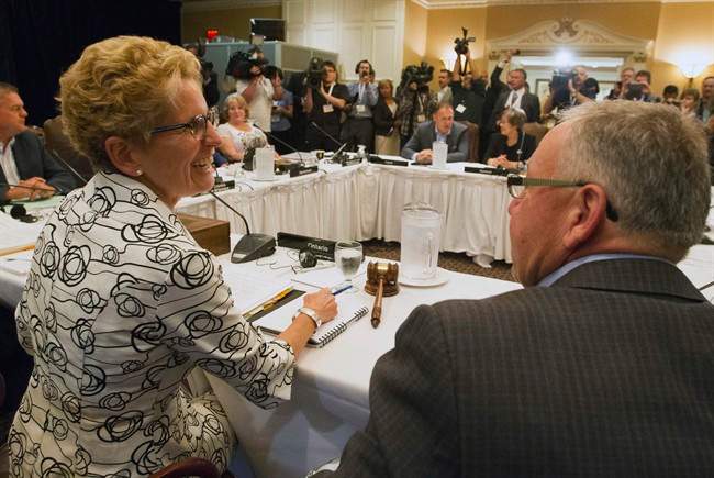 Ontario Premier Kathleen Wynne, left, and Nova Scotia Premier Darrell Dexter talk as premiers gather for the Council of the Federation summer meeting in Niagara-on-the-Lake, Ont., Thursday, July 25, 2013. THE CANADIAN PRESS/Aaron Lynett.
