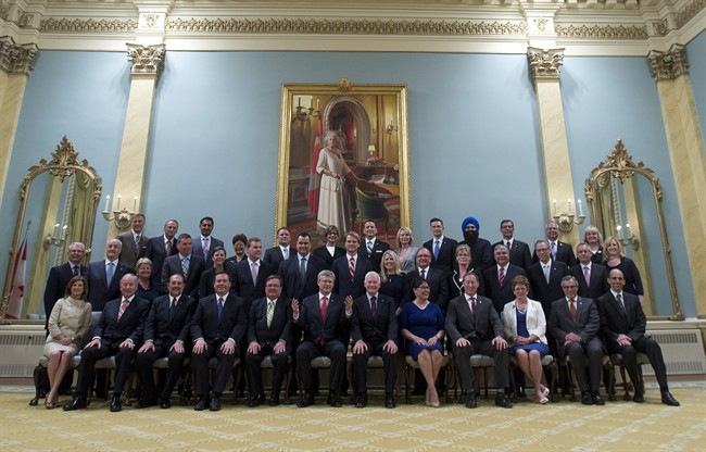 Canadian Prime Minister Stephen Harper, front centre, poses for a group photo with the Cabinet announced during a ceremony at Rideau Hall in Ottawa on Monday, July 15, 2013.