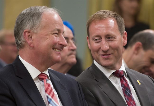 Justice Minister Peter MacKay, right, speaks with National Defence Minister Rob Nicholson during a cabinet swearing in ceremony at Rideau Hall in Ottawa on July 15, 2013. THE CANADIAN PRESS/Adrian Wyld