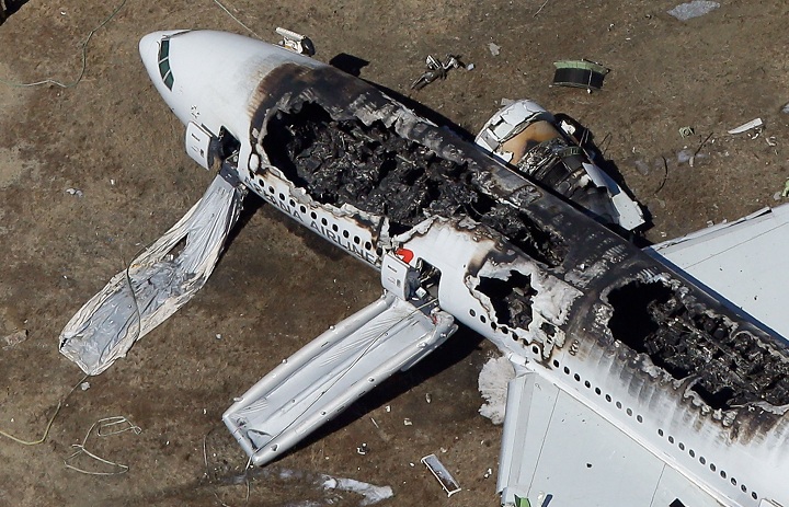 A Boeing 777 airplane lies burned near the runway after it crash-landed at San Francisco International Airport July 6, 2013 in San Francisco, California. 
