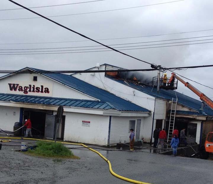 Firefighters in the remote community of Bella Bella, B.C. work at extinguishing a fire in their local store on July 12, 2013.