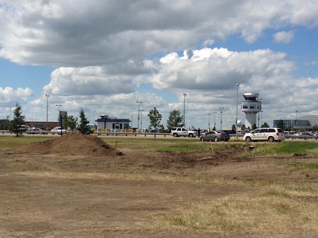 Saskatoon police investigate a possible suspicious package in the parking lot at John G. Diefenbaker Airport on Tuesday.