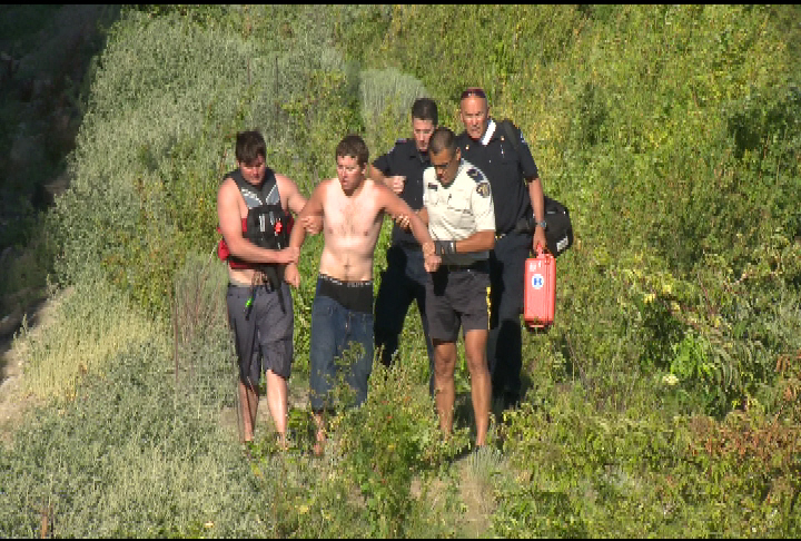 The man is escorted by authorities after crashing a personal watercraft into the  floating bridge. 