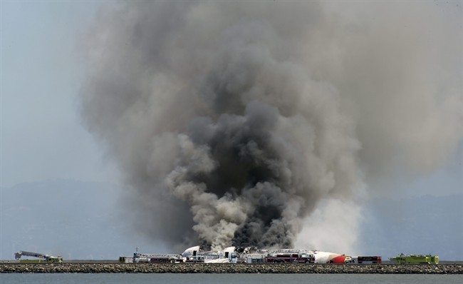 Smokes rises from Asiana Flight 214 after it crashed at San Francisco International Airport in San Francisco, Saturday, July 6, 2013.