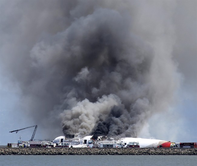 Fire crews work the crash site of Asiana Flight 214 at San Francisco International Airport in San Francisco, Saturday, July 6, 2013. 