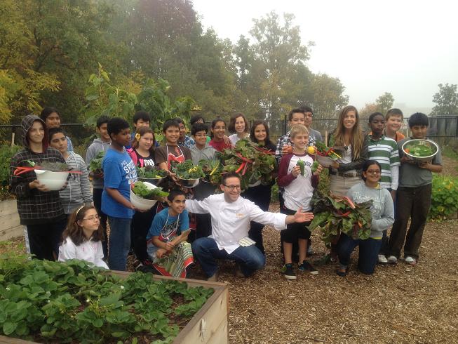 Executive Chef Jason Bangerter poses with Chris Hadfield Public School students who harvested vegetables from their organic garden .